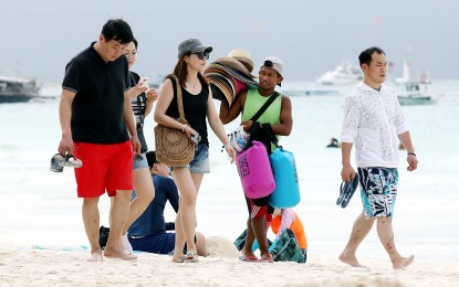 <p>Tourists in Boracay <em>(PNA file photo)</em></p>
